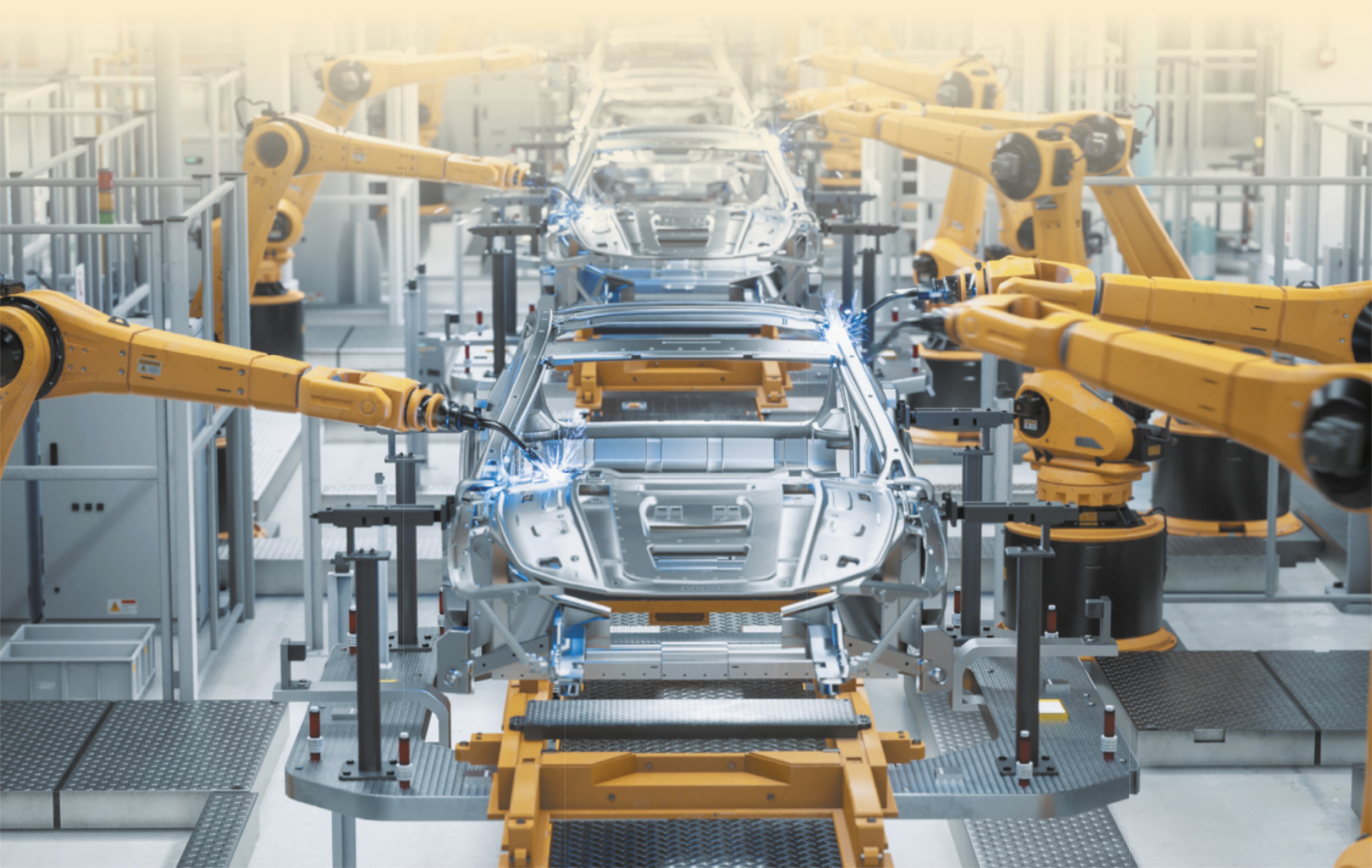 Imagem de robô montando carros em fábrica.