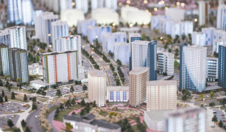 Imagem de maquete de uma cidade com prédios, ruas e árvores.