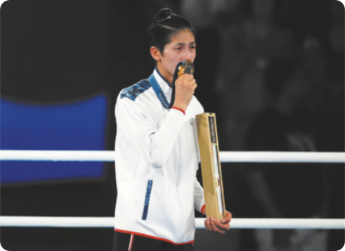 Fotografia de Lin Yu-ting. Ela é uma mulher de cabelos curtos, segurando com uma das mãos uma medalha de ouro diante dos lábios, com uma caixa com um diploma na outra mão.
