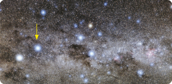 Imagem de um sistema estelar. Na imagem vários pontos de luz, um está em destaque, com uma seta apontando 'Alpha Centauri'.