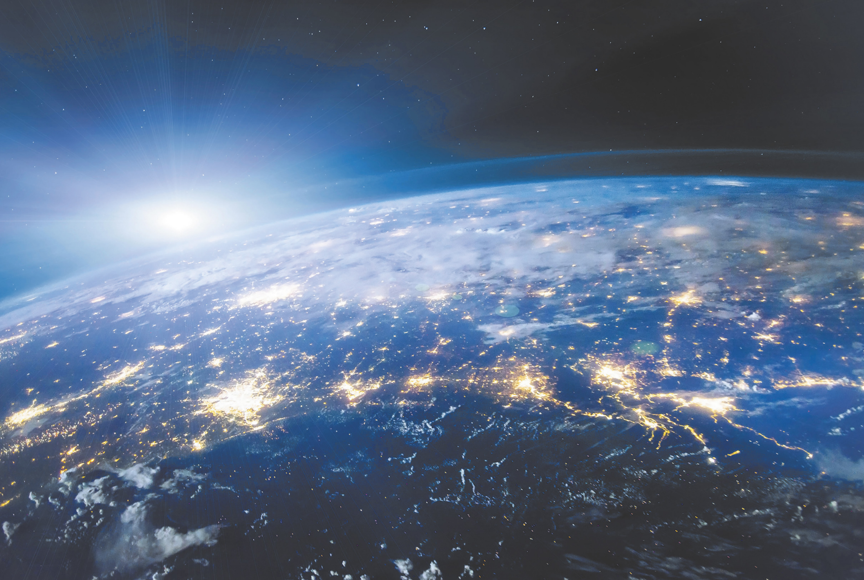 Fotografia de uma parte do planeta Terra, vista do espaço, com vários pontos iluminados.