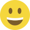 Emoji formado por um círculo amarelo, com olhos pretos e um sorriso largo que mostra os dentes.