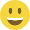Emoji formado por um círculo amarelo, com olhos pretos e um sorriso largo que mostra os dentes.