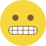 Emoji formado por um círculo amarelo, com olhos pretos e dentes cerrados.