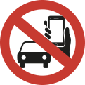 Imagem de uma placa de trânsito em formato circular, com borda vermelha e fundo branco. No centro, há o desenho de um carro e de uma mão segurando um celular. Uma faixa diagonal vermelha atravessa a imagem.