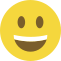 Emoji formado por um círculo amarelo, com olhos pretos e um sorriso largo que mostra os dentes.