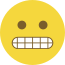 Emoji formado por um círculo amarelo, com olhos pretos e dentes cerrados.
