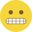 Emoji formado por um círculo amarelo, com olhos pretos e dentes cerrados.