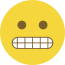 Emoji formado por um círculo amarelo, com olhos pretos e dentes cerrados.
