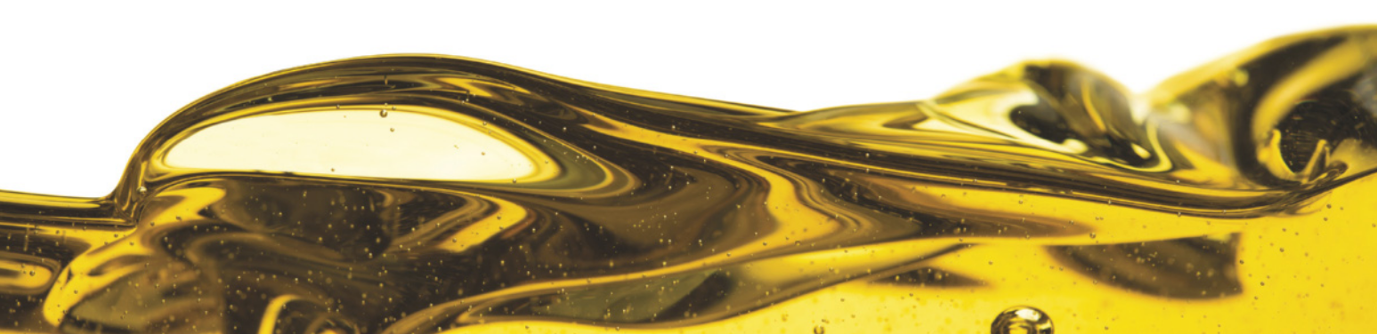 Imagem de um líquido em movimento, em tons de amarelo. Há pequenas bolhas visíveis, e áreas com brilhos e sombras.