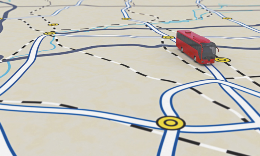Imagem de um mapa ilustrado em perspectiva com várias ruas e rotatórias interligadas, representadas por linhas azuis, pretas e tracejadas. Um ônibus vermelho em miniatura está posicionado sobre uma das vias, como se estivesse trafegando pelo mapa. O cenário simula um sistema de navegação por GPS, com destaque para os caminhos possíveis e pontos de conexão.