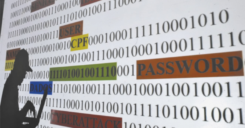 Imagem com fundo de códigos binários (0 e 1) onde aparecem, em destaque, palavras como “PASSWORD”, “CPF”, “USER”, “DADOS” e “CYBERATTACK” em diferentes cores. À esquerda, vê-se a silhueta de uma pessoa com chapéu operando um notebook, representando um hacker. A imagem simboliza o roubo de informações pessoais na internet e destaca riscos relacionados à segurança digital e à proteção de dados.
