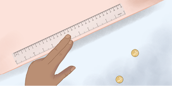 Ilustração de uma mão segurando a régua que está na borda da bancada. As duas moedas estão no chão.