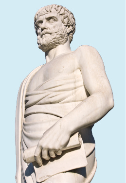 Fotografia de uma estátua de um homem com cabelo curto e barba encaracolada. Ele usa um manto e segurando um papel em rolo.