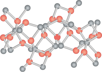 Ilustração de uma estrutura tridimensional representado por esferas cinzas e vermelhas conectadas por palitos. As esferas cinzas e vermelhas estão interligadas pelos palitos de forma intercalada, formando uma estrutura tridimensional.