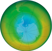 Ilustração de um mapa hemisférico centrado no polo sul. A Antártica está representada em tons de azul claro no centro da imagem. Ao redor, há uma variação de cores em gradiente, indo de azul claro no centro para azul mais escuro, verde claro, amarelo e tons de laranja na borda externa do círculo.