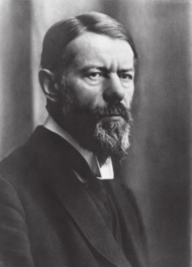 Fotografia em preto e branco de Max Weber. Ele é branco, possui barba e cabelo liso partido de lado e usa casaco.