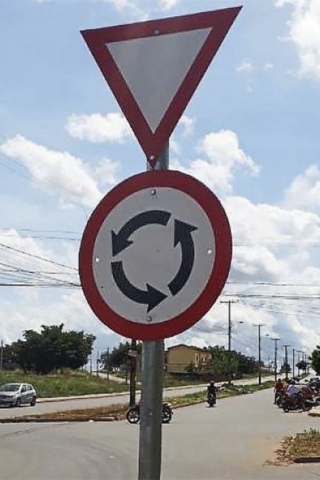Foto de placas indicando que há uma rotatória e, também, que o motorista deve dar a preferência.